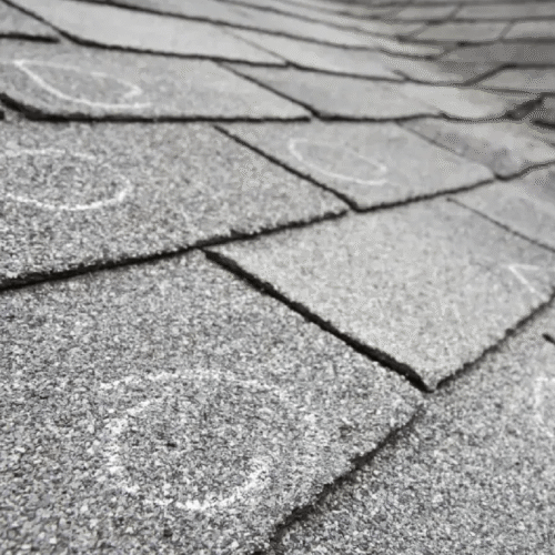 Close-up of rectangular stone paving slabs with dark grout lines and visible wear.